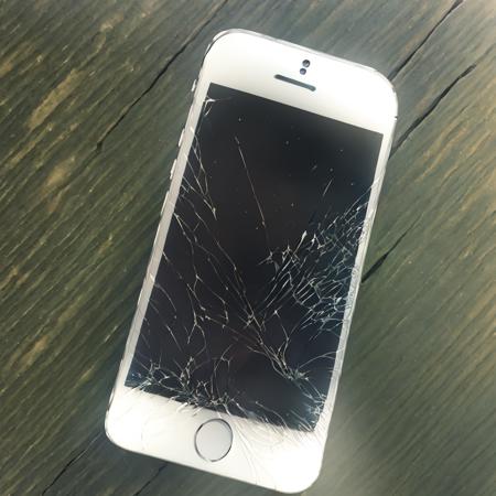 old white iphone with broken screen