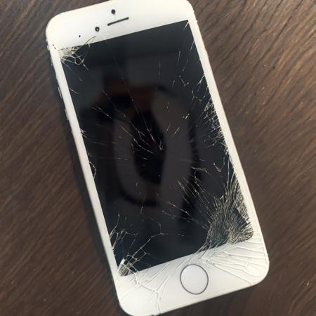 old white iphone with broken screen