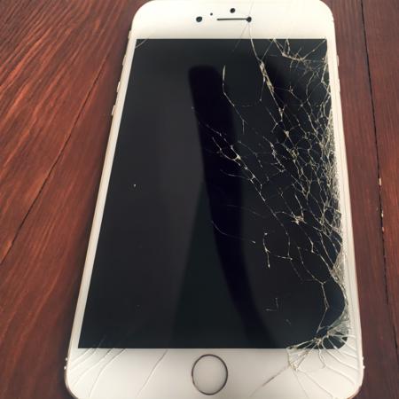 old white iphone with broken screen